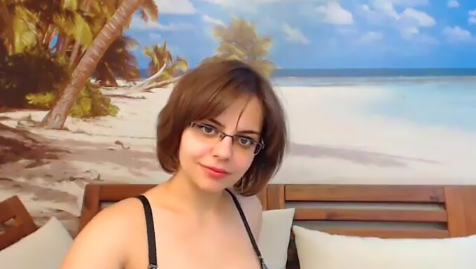 Amateur Latina with glasses strips and shows off big boobs